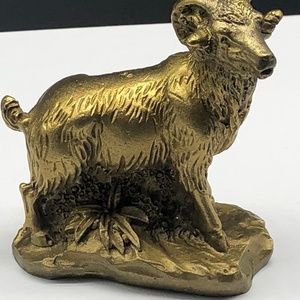 Gold colored ram figurine made of brass